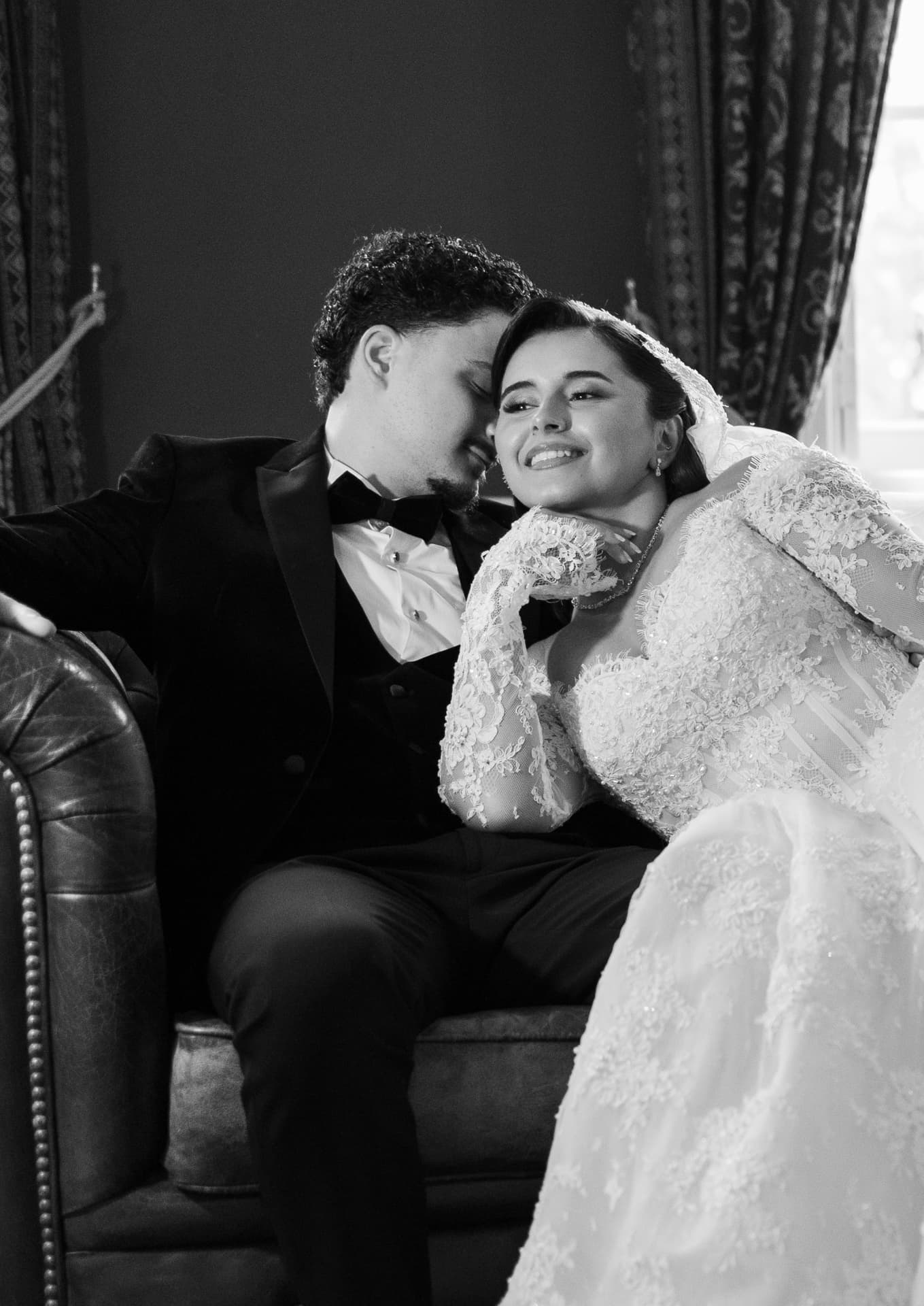 Black-and-white portrait of newlyweds seated close together