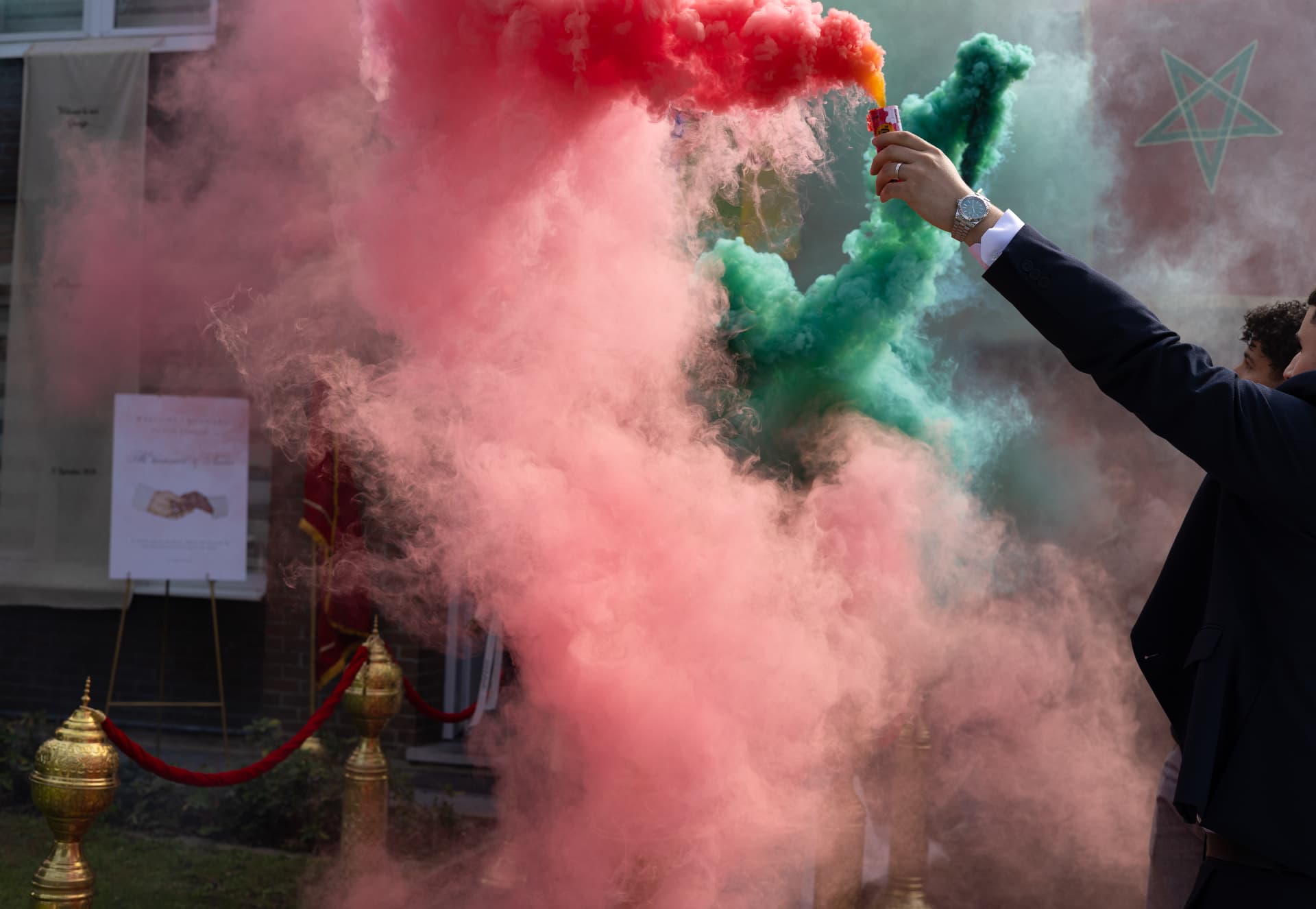 A wedding celebration with pink and green smoke